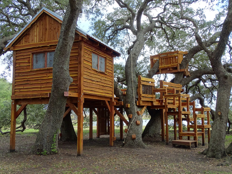 Very large custom treehouse made from Texas Cedar with live edge accents. Markham, Tx.